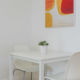 White dining table and two chairs in Kings Cross 1 bedroom apartment