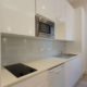 Fully equipped modern white kitchenette in Holloway London studio flat