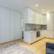 One bedroom apartment with built in storage space, modern kitchen and armchairs